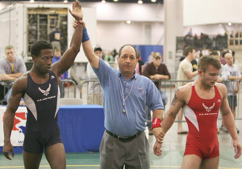 Capt. Anthony Brooker is declared the winner over his opponent and fellow teammate Senior Airman Jared Moreland  at the USA National Senior Men's and Women's Wrestling Championships in Las Vegas on Saturday, April 15, 2006. Captain Brooker finished seventh overall. He is stationed at Vandenberg Air Force Base, Calif., and Airman Moreland is at Cannon AFB, N.M. (U.S. Air Force photo/Master Sgt. Robert W. Valenca) 
