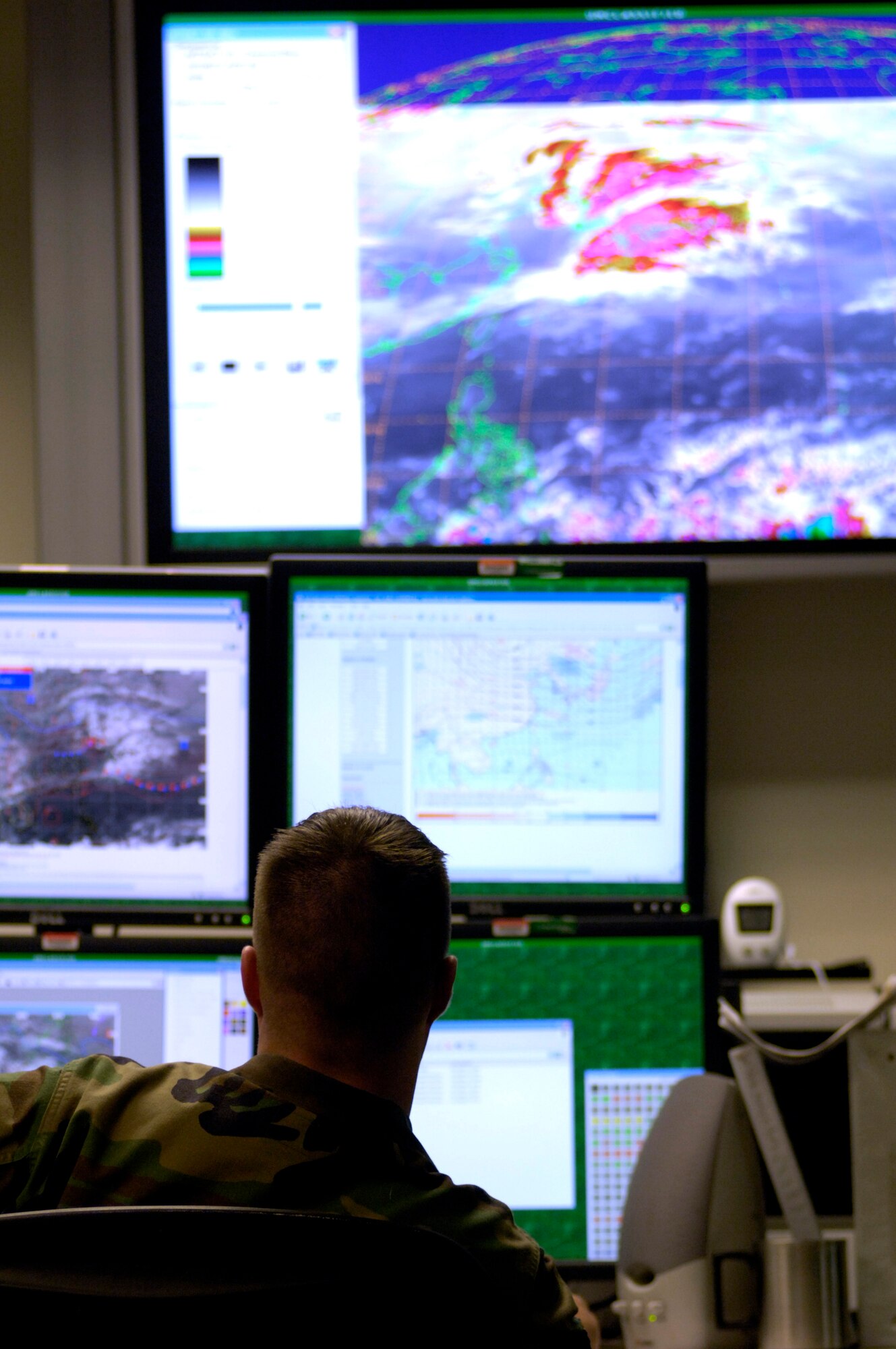 Master Sgt. Charles Hoffman looks over weather imagery of Korea and Japan on the operations floor Tuesday, April 18, 2006, at Hickam Air Force Base, Hawaii. Sergeant Hoffman is a flight chief with the 17th Operational Weather Squadron, which provides Pacific Air Forces with tailored operational forecasts. (U.S. Air Force photo/Tech. Sgt. Shane A. Cuomo)