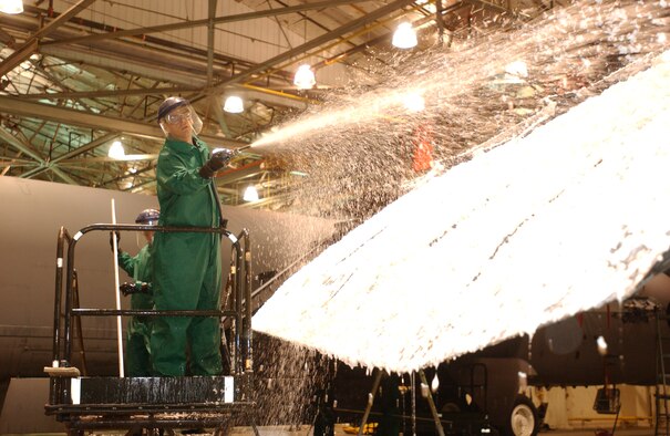 Lt. Col. David Foote, 5th Aircraft Maintenance Squadron, washes down a B-52H Stratofortress wing during an aircraft wash March 31. People could elect their boss or squadron mates to help wash the plane for 25 cents a vote to help raise money for the Air Force Assistance Fund. The event raised $2,388. (U.S. Air Force Photo by Airman Joe Rivera)