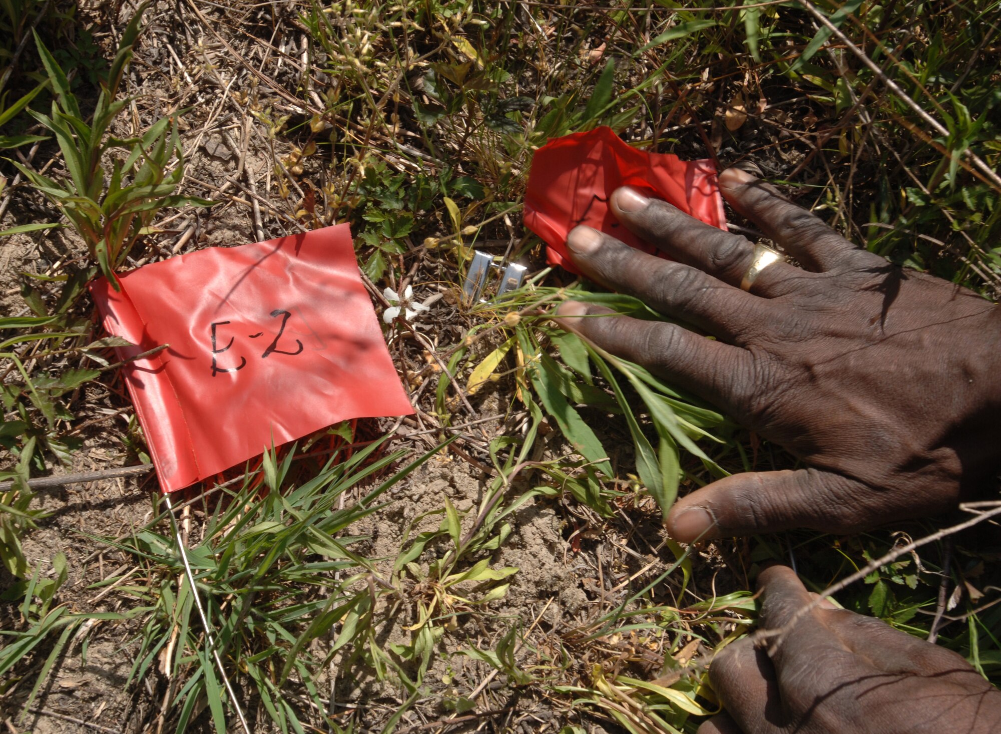 A member of Shaw's search and recovery team marks the location of personal effects during an exercise at Poinsett Range April 20.