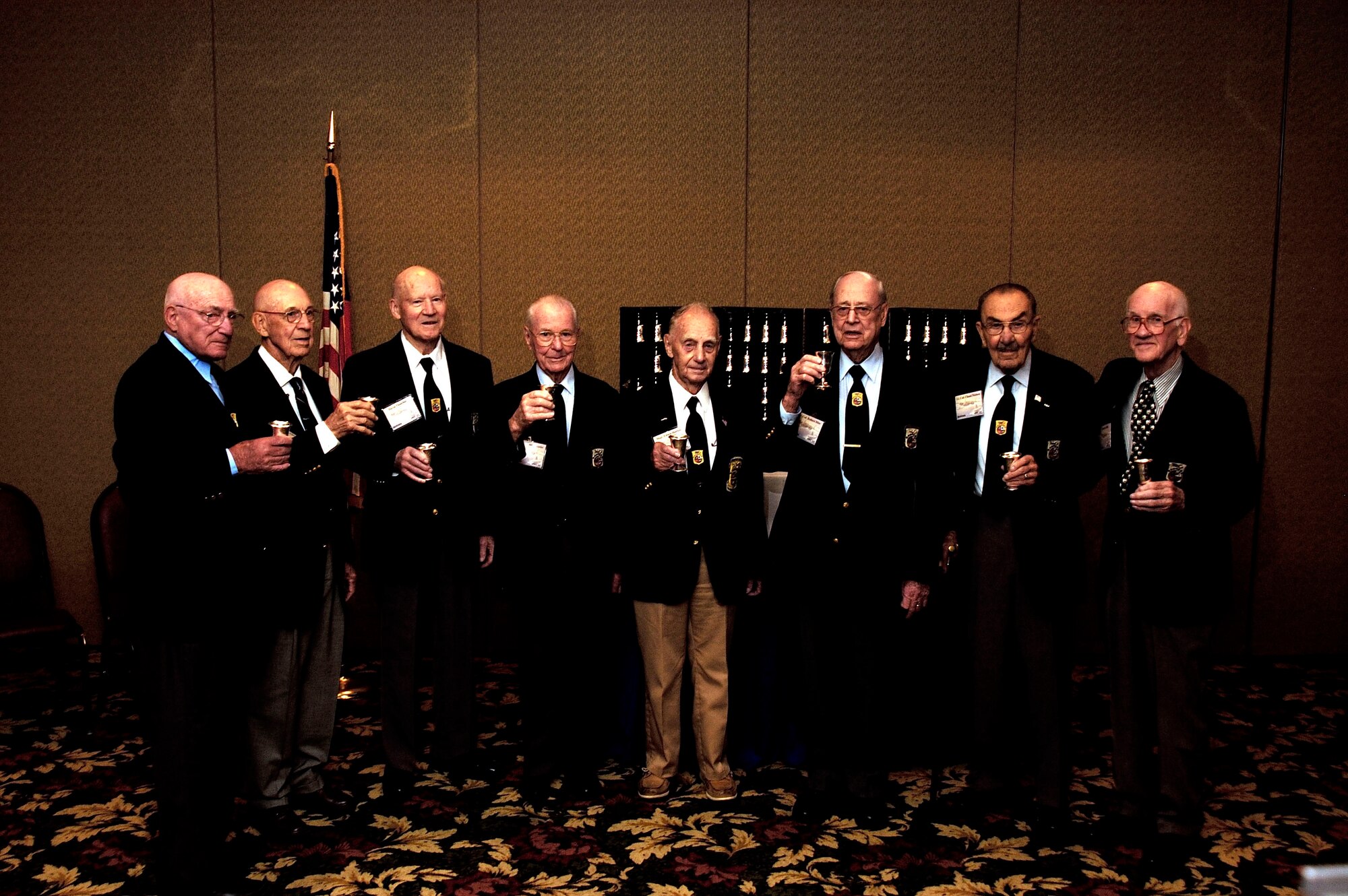 DAYTON, Ohio - (left to right) Doolittle Raiders Col. (Ret.) Bill Bower, Lt. Col. (Ret.) Dick Cole, David Thatcher, Lt. Col. (Ret.) Frank Kappeler, MSgt. (Ret.) Ed Horton, Lt. Col. (Ret.) Bob Hite, Lt. Col (Ret.) Chase Nielson and Tom Griffin prepare to toast during the goblet ceremony during the Doolittle Raider Reunion on April 18, 2006 at the National Museum of the U.S. Air Force. (Air Force photo by Spencer Lane)    