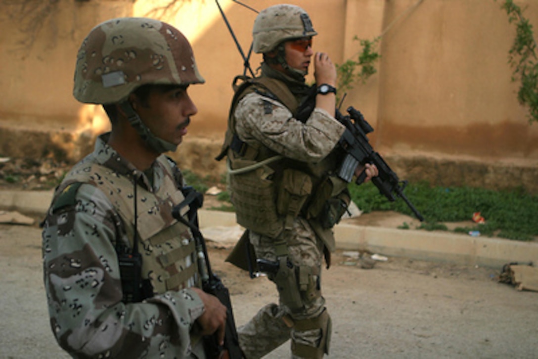U.S. Marine Corps Capt. Jim H. Brady (right) and an Iraqi army soldier with the 3rd Battalion, 2nd Brigade, 7th Iraqi Army Division conduct a foot patrol in Rawah, Iraq, on April 14, 2006. Brady is assigned to the 3rd Battalion, 11th Marine Regiment. 