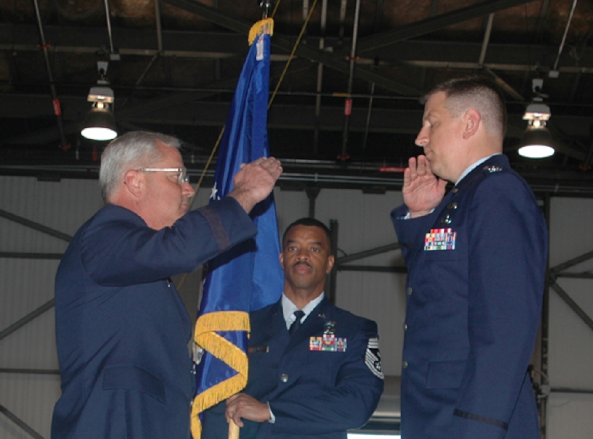 Col. Stan Sheley (right) salutes Brig. Gen. James Melin, 434th Air Refueling Wing commander, upon assuming command of the 434th Maintenance Group. Chief Master Sgt. Chris Jackman, first sergeant for the 434th MXG, assists with the ceremony. (U.S. Air Force photo/SrA Jonathan Jones)