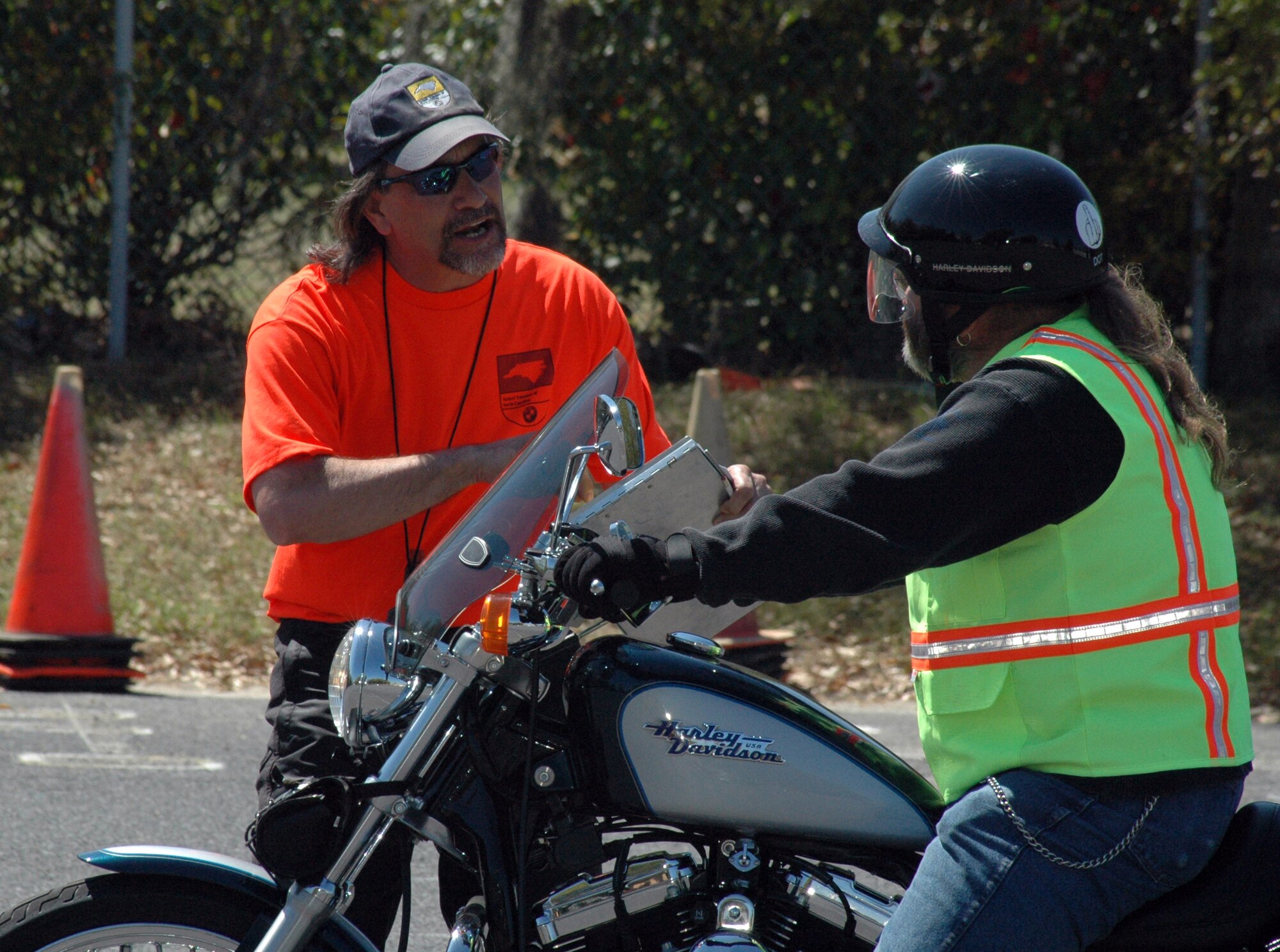 Rider coach candidate Steve Brunner of the 66th Air Operations Squadron from Pope Air Force Base, N.C., (left) gives advise to student Terry Pugh, 437th Logistics Readiness Squdron, during the skills exercise.  (Photo by Tech. Sgt. Mary Hinson, USAFR)
