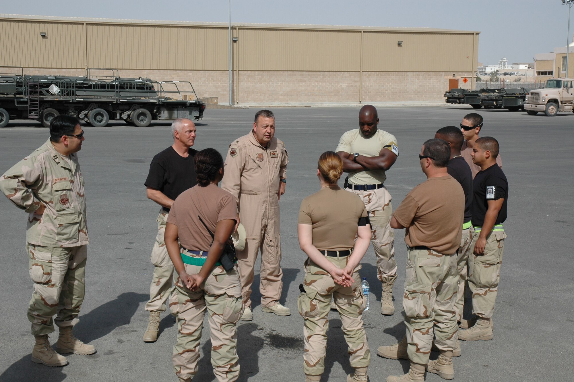 Col. Gary Cook, commander of the 315th Airlift Wing at Charleston AFB, S.C. (center), talks to deployed members of the Charleston based aerial port squadrons.  The colonel recently traveled to the Middle East to make a surprise visit to see his deployed troops as they were working in Kuwait.  (Photo by 1st Lt. Wayne Capps, USAFR)