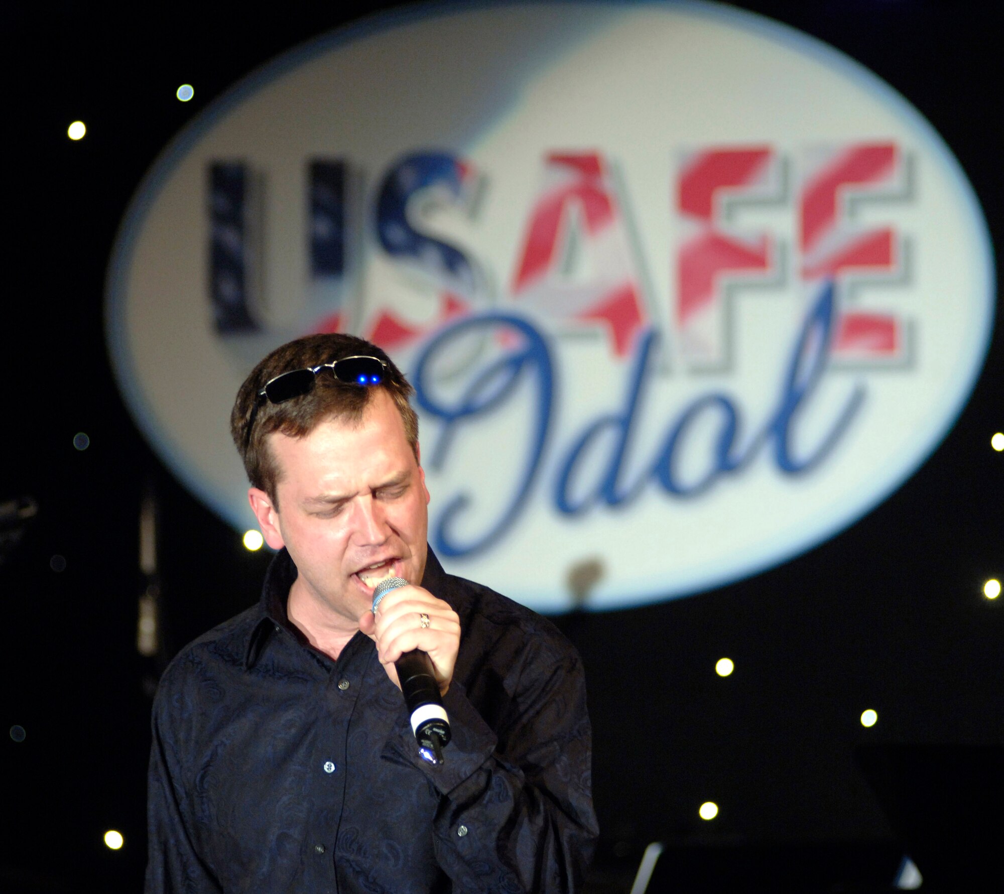 Maj. Larry Speer opens United States Air Forces in Europe's "USAFE Idol" contest singing "Born To Run" Saturday, April 22, 2006, at Ramstein Air Base, Germany. Major Speer, the 2005 USAFE Idol winner, is a C-20 pilot with the 76th Airlift Squadron at Ramstein. (U.S. Air Force photo/Master Sgt. John E. Lasky) 
