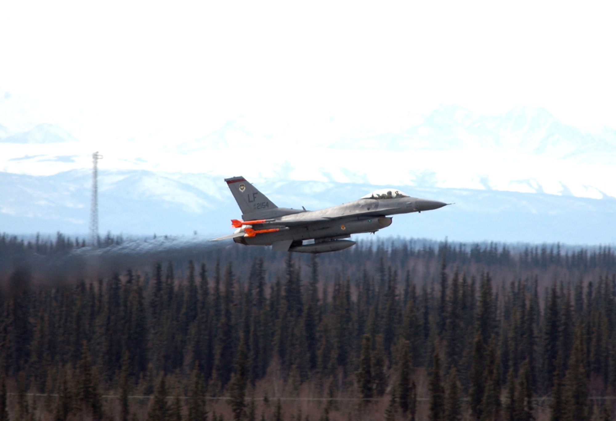 An F-16 Fighting Falcon from the 63rd Fighter Squadron at Luke Air Force Base, Ariz., takes off from Eielson AFB, Alaska, during a familiarization flight at Red Flag-Alaska 06-2. (U.S. Air Force photo/Tech. Sgt. Jeff Walston) 

