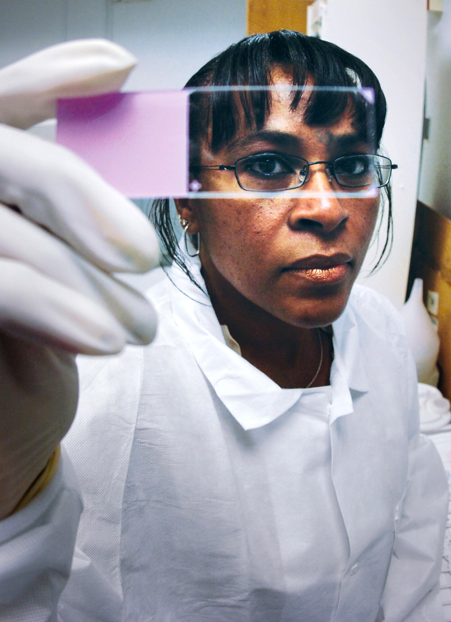 Helena Smalls views a slide of a fungus specimen. Ms. Smalls is a histopathology technician with the 89th Medical Support Squadron pathology department at Andrews Air Force Base, Md. (U.S. Air Force photo/Bobby Jones)