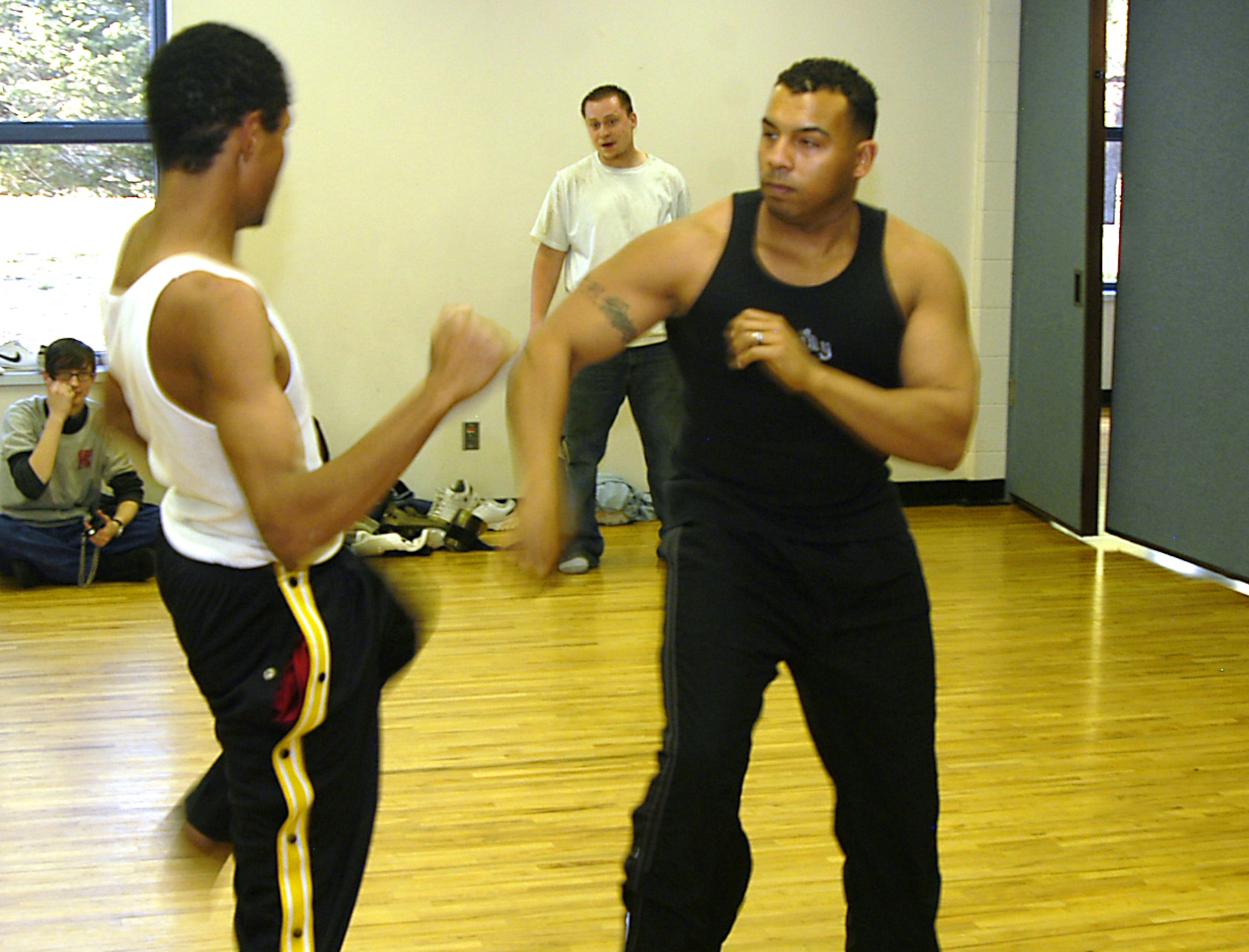 Staff Sgt. Dave Armstrong, right, spars with Santiago, 18, at a local community center in Colorado Springs, Colo., on Tuesday, April 11, 2006. Sergeant Armstrong, known to his students as Sensei Dave, teaches martial-arts classes for at-risk teens. Sergeant Armstrong is an information manager with Detachment 2 of the 17th Test Squadron at Cheyenne Mountain Air Force Station, Colo. (U.S. Air Force photo/Staff Sgt. Don Branum)