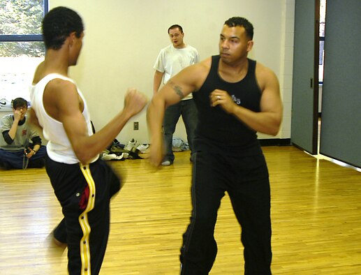 Staff Sgt. Dave Armstrong, right, spars with Santiago, 18, at a local community center in Colorado Springs, Colo., on Tuesday, April 11, 2006. Sergeant Armstrong, known to his students as Sensei Dave, teaches martial-arts classes for at-risk teens. Sergeant Armstrong is an information manager with Detachment 2 of the 17th Test Squadron at Cheyenne Mountain Air Force Station, Colo. (U.S. Air Force photo/Staff Sgt. Don Branum)