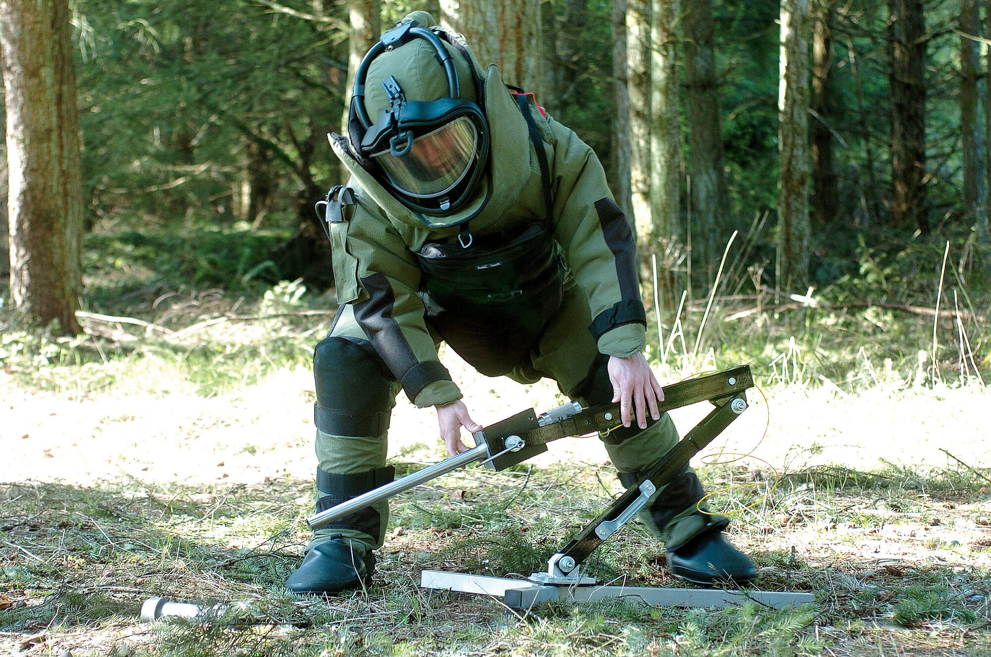 MCCHORD AIR FORCE BASE, Wash., - Airman First Class Shawn Lundgren approaches a device using a Percussion Actuated Neutralizer during an Render Safe Procedure exercise.  Airman Lundgren is an explosive ordnance disposable specialists assigned to the 446th Civil Engineer Squadron, an Air Force Reserve unit here. (U.S. Air Force photo by Abner Guzman)


