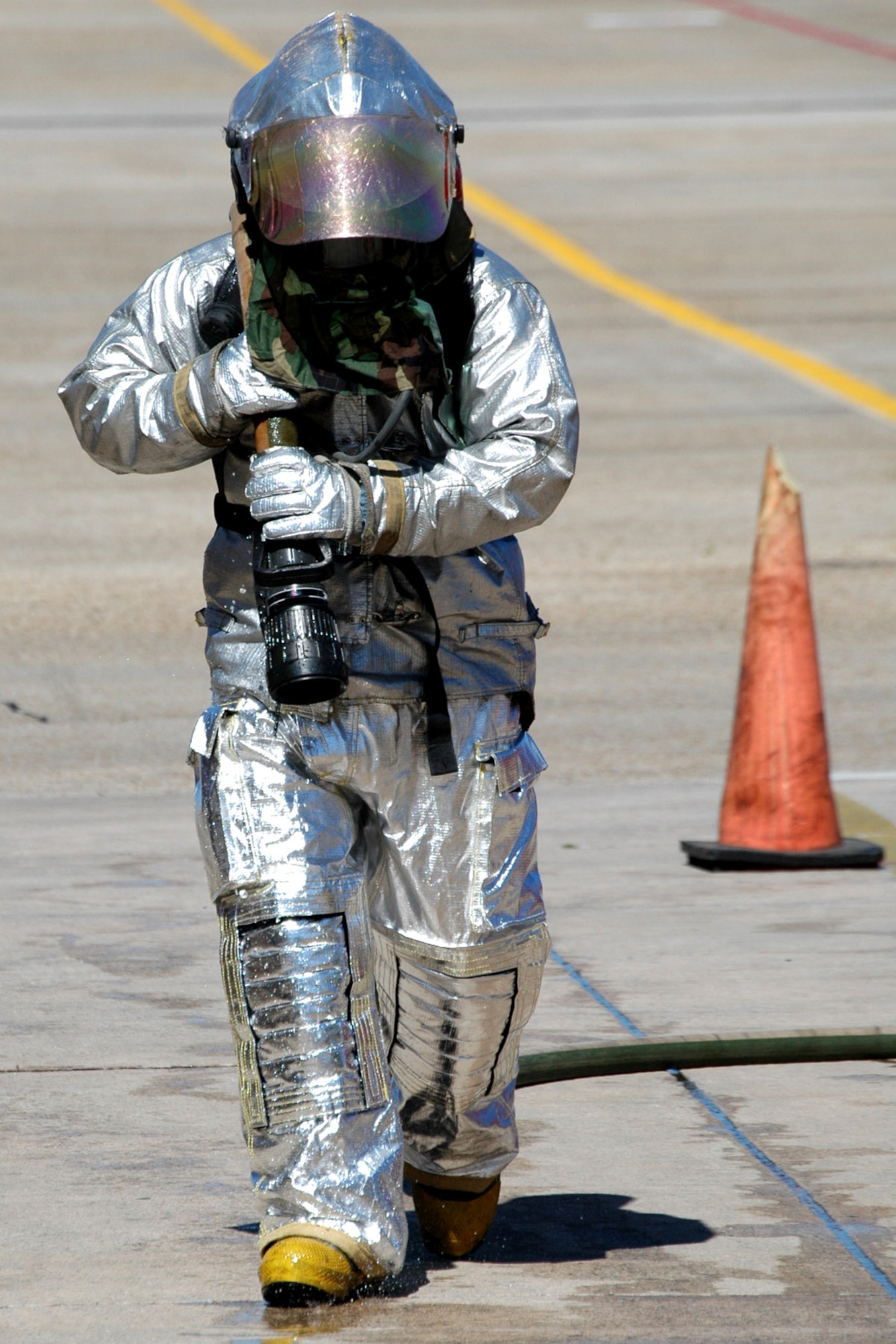 Senior Airman Stephen Finkenhoefer drags a hose while testing the Air Force's new firefighter protective suit at Eglin Air Force Base, Fla. He is a firefighter with Eglin's 96th Civil Engineer Squadron. (U.S. Air Force photo/Senior Airman Mike Meares)
