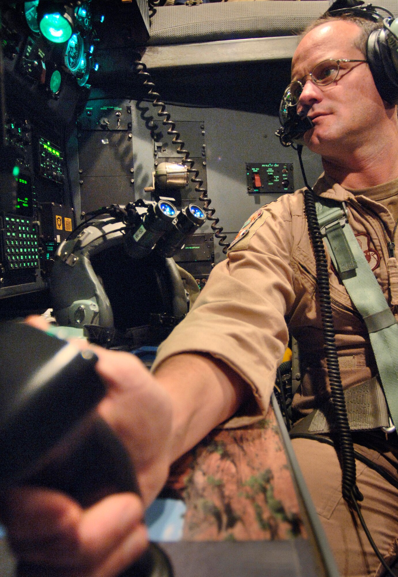 Capt. Fred Phelan uses the joystick controls of the APN214 navigation system to designate waypoints on a display screen on Wednesday, April 19, 2006, over Southwest Asia. When the aircraft is in autopilot mode, it can fly itself to the series of waypoints regardless of weather or other flight factors. Captain Phelan is a Reserve navigator deployed to the 746th Expeditionary Airlift Squadron in support of Operation Iraqi Freedom. He is from the 327th Airlift Squadron at Willow Grove Air Reserve Station, Pa. (U.S. Air Force photo/Master Sgt. Lance Cheung)