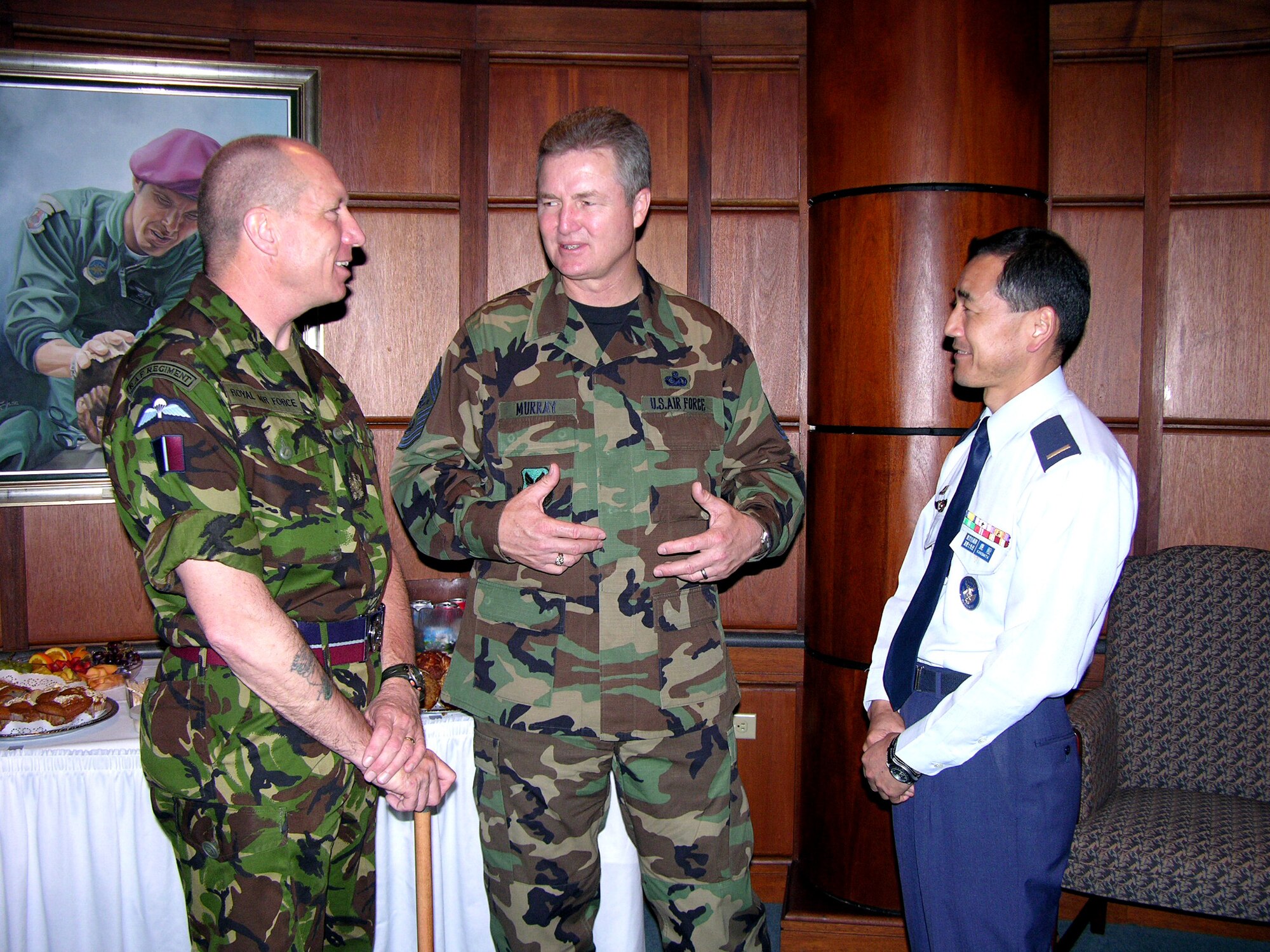 Chief Master Sgt. of the Air Force Gerald R. Murray discusses the progress of the Worldwide Command Chiefs Conference with his British counterpart, Warrant Officer Bob Loughlin, and his Japanese counterpart, Warrant Officer Ryuichi Kanomata, during a break at the Air Force Senior NCO Academy at Maxwell-Gunter Air Force Base, Ala., on Monday, April 24, 2006.  (U.S. Air Force photo)