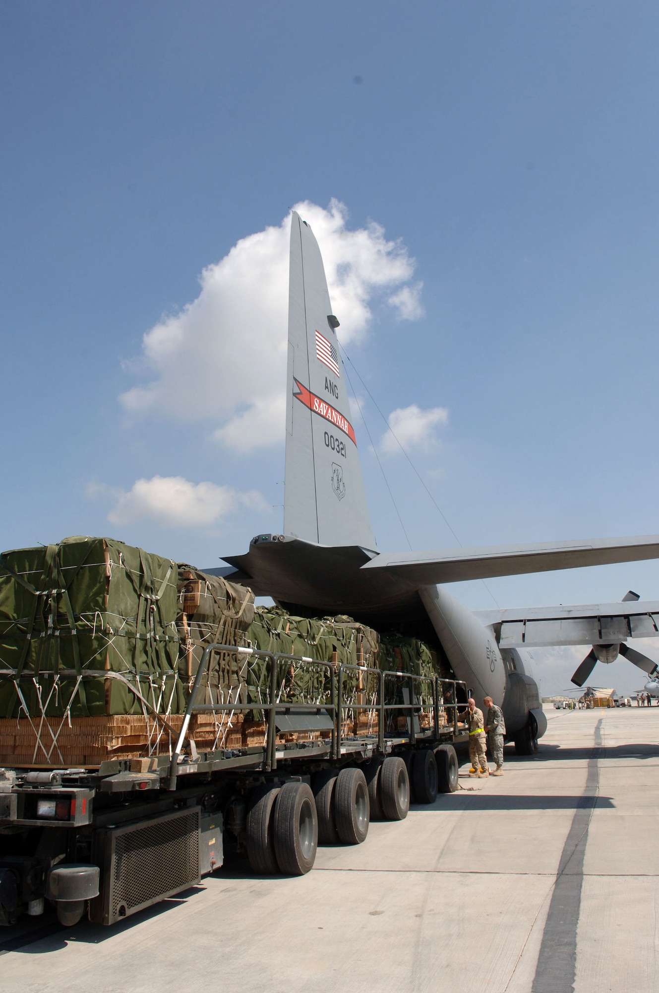 Pallets destined for Afghani villages are loaded onto a C-130 Hercules at Bagram Air Base, Afghanistan, on Saturday, April 15, 2006, in support of Operation Mountain Lion. (U.S. Air Force photo/Staff Sgt. Jennifer Redente) 
