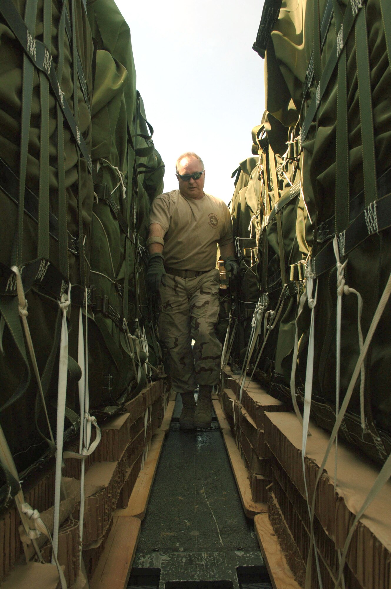 Chief Master Sgt. Gary Lanham inspects pallets before they are loaded onto a C-130 Hercules from the 774th Expeditionary Airlift Squadron on Saturday, April 15, 2006. Chief Lanham is the squadron's loadmaster superintendent. He is deployed to Bagram Air Base, Afghanistan, from Kulis Air National Guard Base, Alaska. (U.S. Air Force photo/Staff Sgt. Jennifer Redente)