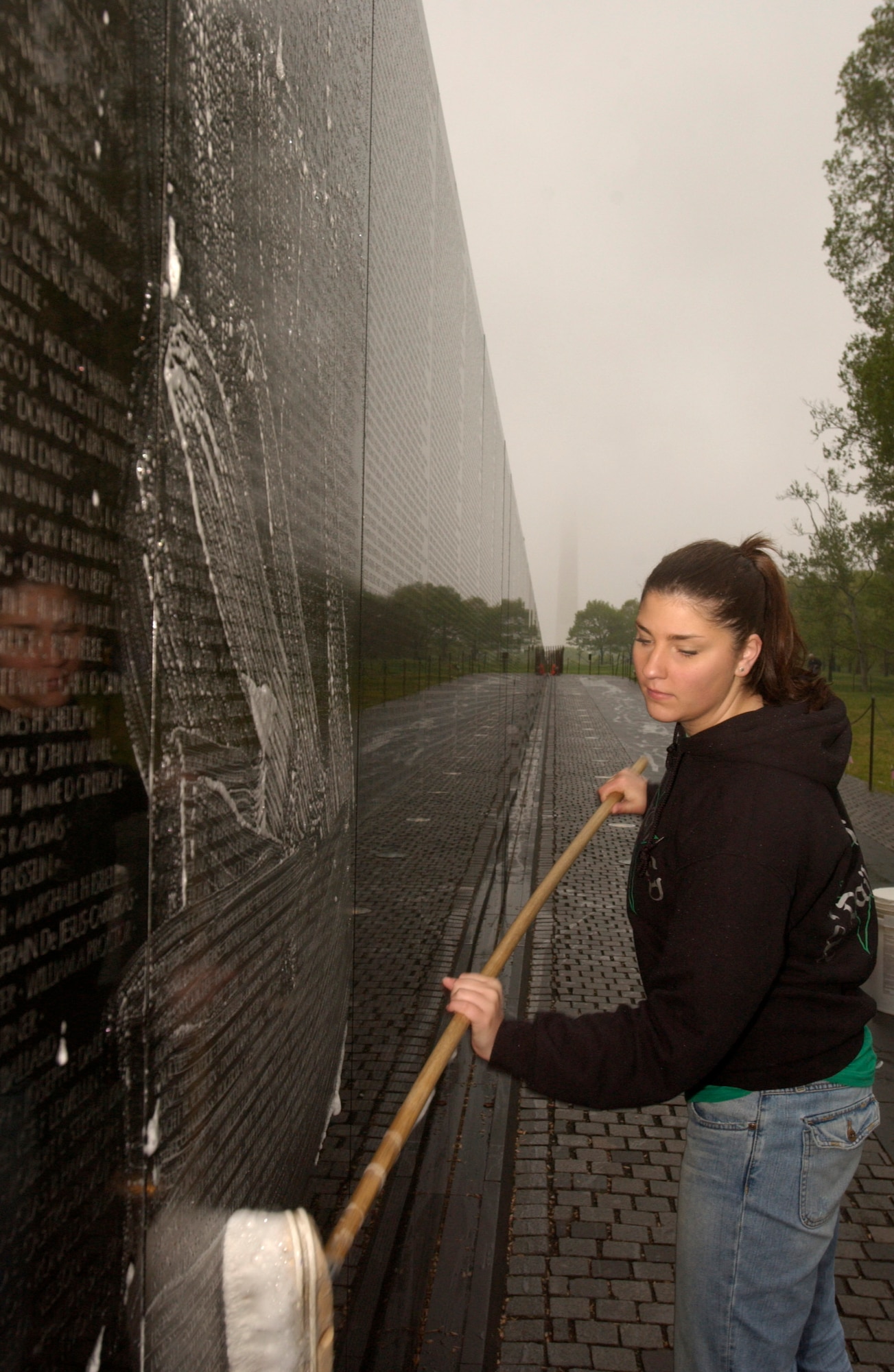 Airman 1st Class Laura Dailey scrubs the Vietnam Veterans Memorial on Saturday, April 22, 2006. More than 140 members of the Air Force Sergeants Association met in the nation's capital to clean the memorial early in the morning before tourists arrived. Airman Dailey is assigned at Pope Air Force Base, N.C. (U.S. Air Force photo/Senior Airman J.G. Buzanowski)
