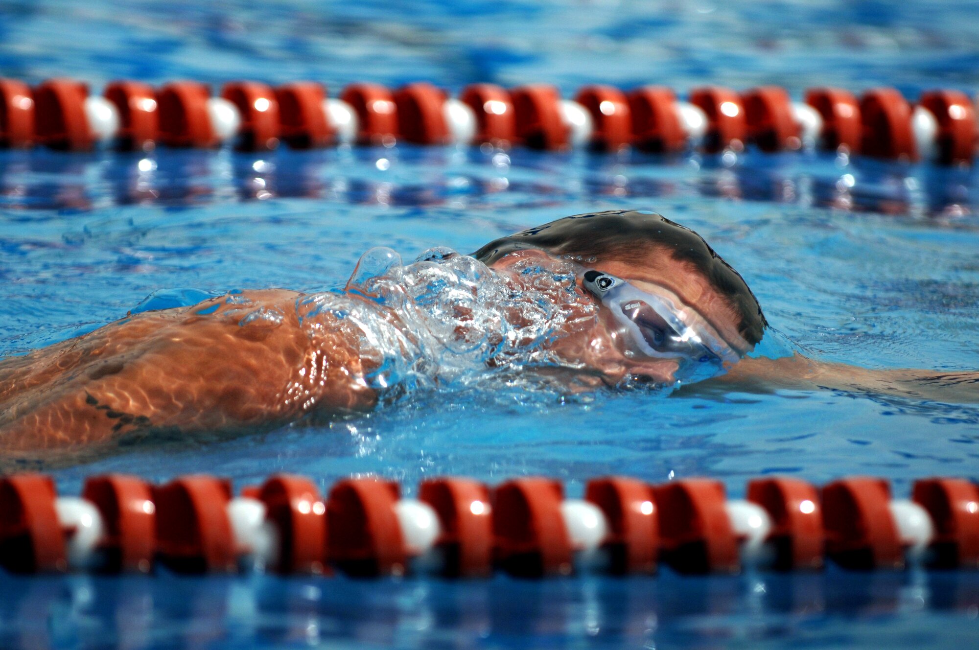 An Airman swims in the 1,600-meter relay during the 379th Air Expeditionary Wing Sports Day on Sunday, April 23, 2006. Other events at the deployed location in Southwest Asia included volleyball, home run derby, basketball, dodgeball, and a "strongman and woman" contest.  (U.S. Air Force photo/Staff Sgt. Joshua Strang) 

