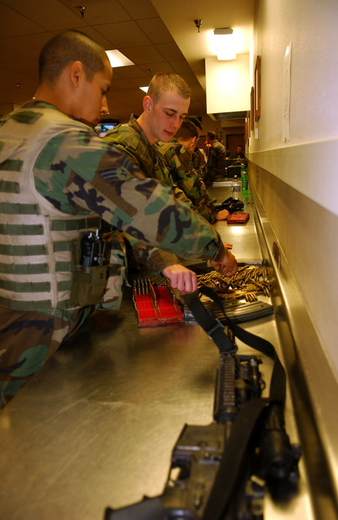 Senior Airman Jorge Rodriguez (left) and Airman 1st Class Dan Raschke block their ammunition after their shift on Friday, April 21, 2006, at Minot Air Force Base, N.D. This procedure ensures all ammunition is accounted for before being turned in. Both Airmen are with the 5th Security Forces Squadron. (U.S. Air Force photo/Staff Sgt Jocelyn Rich)