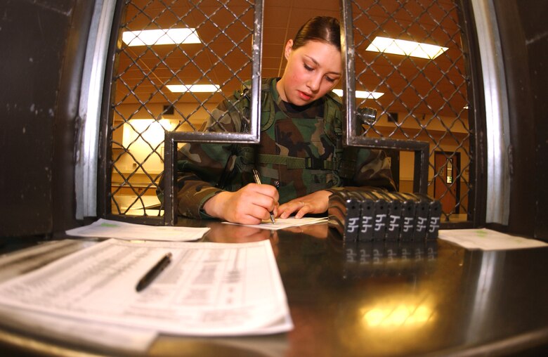 Airman 1st Class Meagan Wells fills out a receipt for ammunition on Friday, April 21, 2006. She is a 5th Security Forces Squadron augmentee at Minot Air Force Base, N.D. When not an augmentee, Airman Wells works in plans and scheduling at the 5th Aircraft Maintenance Squadron. (U.S. Air Force photo/Staff Sgt. Jocelyn Rich)
