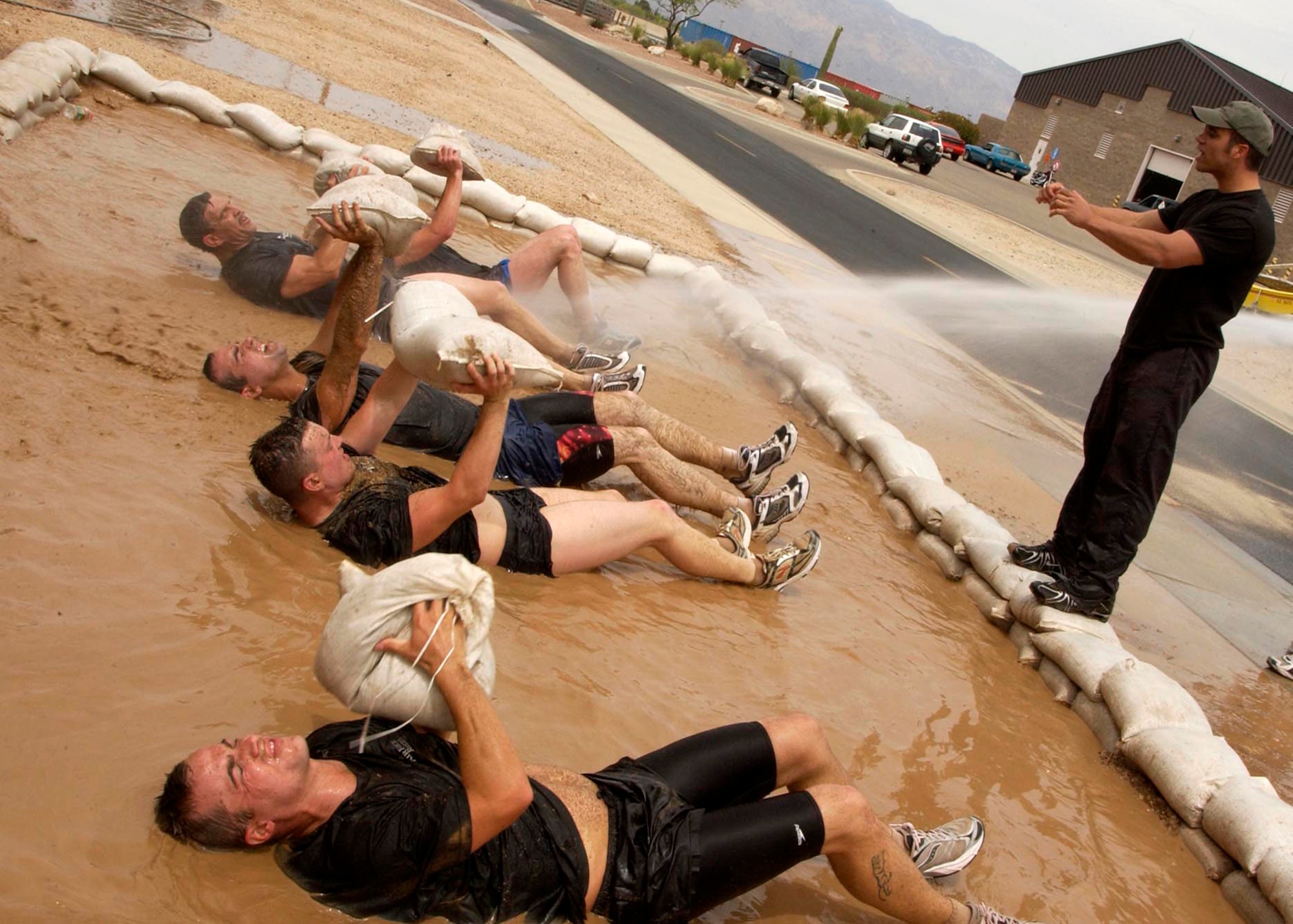 Tech. Sgt. Isaiah Staley challenges applicants during the 306th Rescue Squadron pararescue screening Friday, April 21, 2006, at Davis-Monthan Air Force Base, Ariz. Applicants must pass a timed 3-mile run, 1,500-meter swim, calisthenics and other tasks before proceeding to the 10-week indoctrination course at Lackland AFB, Texas. Sergeant Staley is a pararescueman with the 306th. (U.S. Air Force photo/Airman 1st Class Veronica Pierce) 