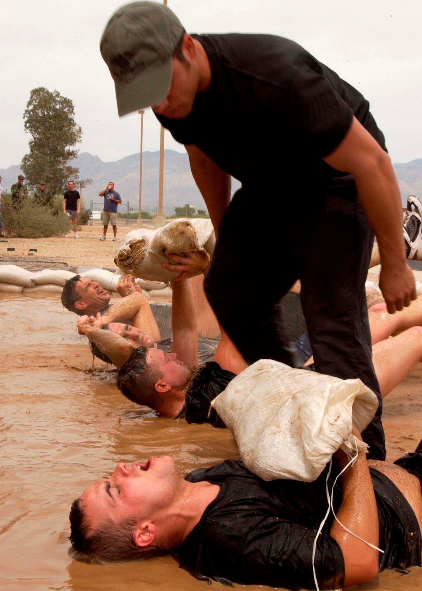 Tech. Sgt. Isaiah Staley monitors an applicant during the 306th Rescue Squadron pararescue screening Friday, April 21, 2006, at Davis-Monthan Air Force Base, Ariz. Applicants must pass a timed 3-mile run, 1,500 meter swim, calisthenics and other tasks before proceeding to the 10-week indoctrination course at Lackland AFB, Texas. Sergeant Staley is a pararescueman with the 306th. (U.S. Air Force photo/Airman 1st Class Veronica Pierce) 