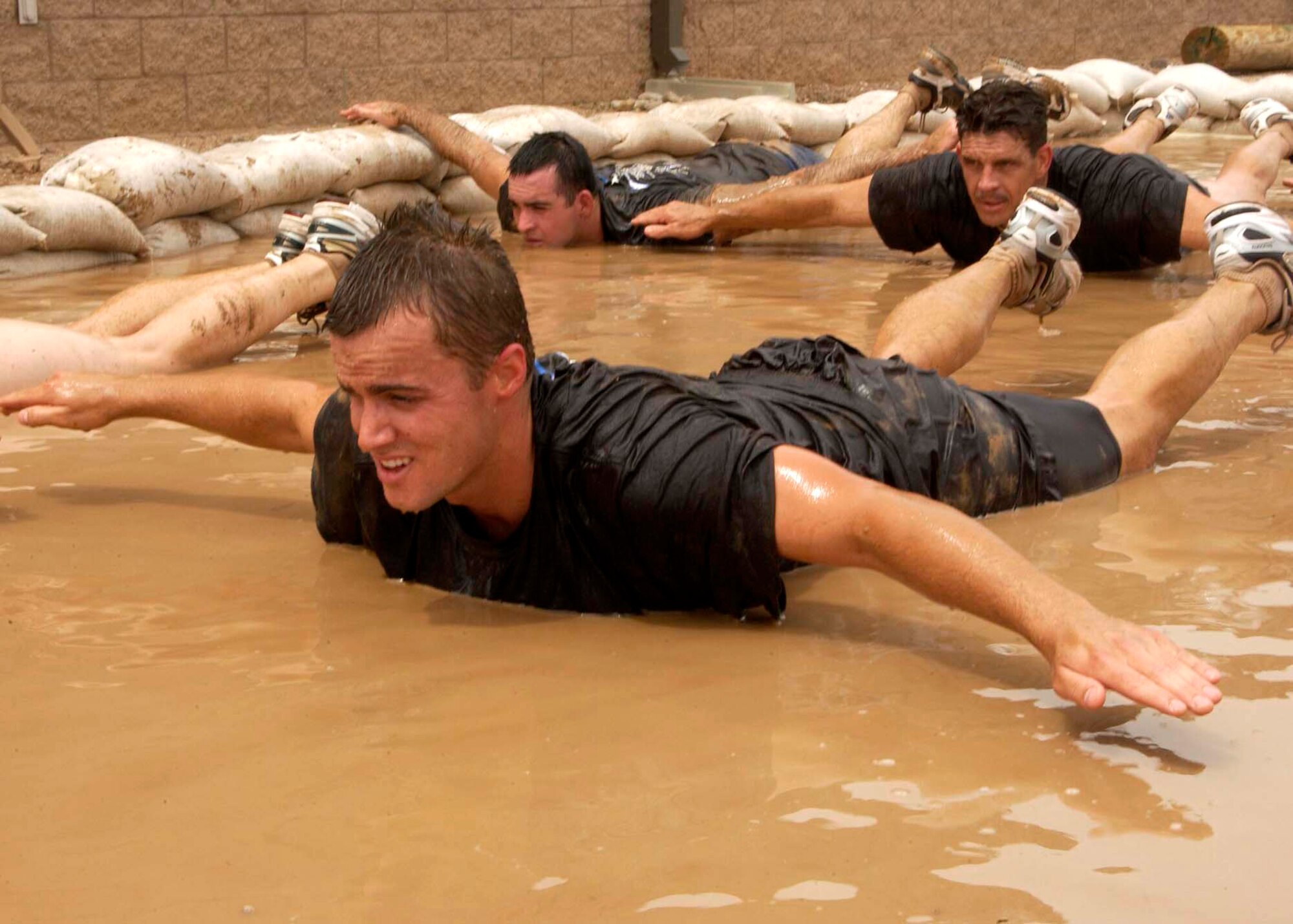 Alan Brumfield simulates a freefall in a mud pit during the 306th Rescue Squadron pararescue screening Friday, April 21, 2006, at Davis-Monthan Air Force Base, Ariz. Military and civilian applicants must pass a timed 3-mile run, 1,500-meter swim, calisthenics and other tasks before proceeding to the 10-week indoctrination course at Lackland AFB, Texas.  (U.S. Air Force photo/Airman 1st Class Veronica Pierce) 
