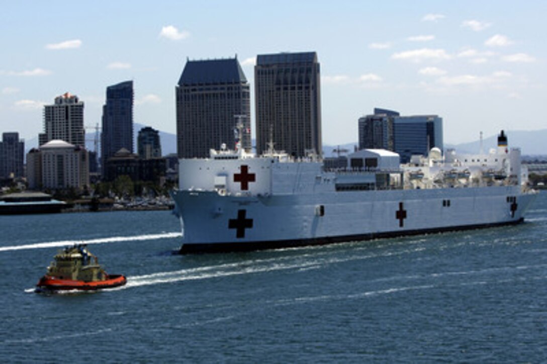 The Military Sealift Command hospital ship USNS Mercy (T-AH 19) glides past downtown San Diego, Calif., as it departs on a five-month humanitarian mission to the Western Pacific and Southeast Asia on April 24, 2006. The shipís mission is being coordinated with host nations in the region and is being carried out in conjunction with non-governmental relief organizations to provide medical, dental and other humanitarian assistance programs ashore and afloat. 