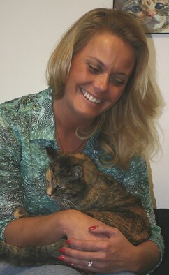 CANNON AIR FORCE BASE, N.M. - Jane West, wife of Col. Scott West, 27th Fighter Wing commander, an avid pet lover,  holds one of the cats living at Sundance Ranch. Sundance receives cats from a variety of places. During last year's hurricanes, they received more than 30 to care for at the ranch. (U.S. Air Force photo by Janet Taylor-Birkey)