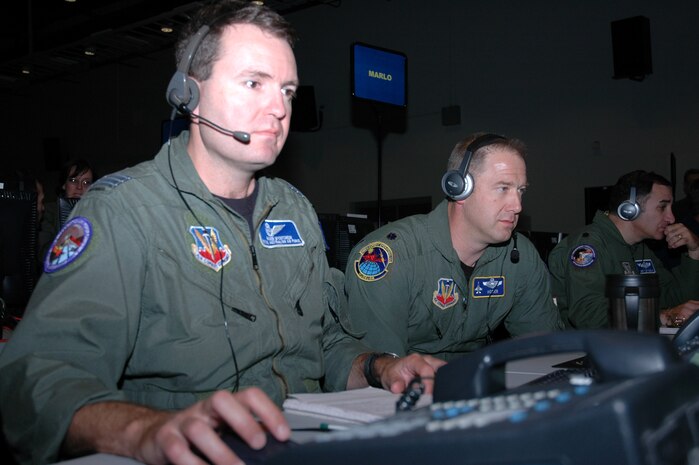 Royal Australian Air Force Wing Commander Roger McCutcheon (left) works with Lt. Col. Mike Heyser in the combined air and space operations center at Joint Expeditionary Force Experiment 2006 at Nellis Air Force Base, Nev. (U.S. Air Force photo/Maj. Richard Johnson)