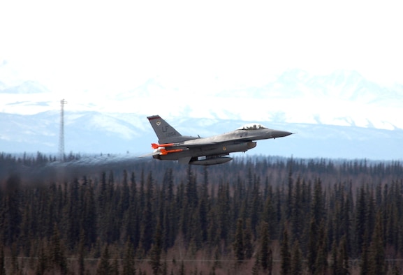 Friendly forces, such as this F-16 Fighting Falcon from the 63rd Fighter Squadron at Luke Air Force Base, Ariz., face a host of "enemy" threats while flying missions during Red Flag-Alaska 06-2 at Eielson AFB, Alaska. These challenges help aircrews practice their warfighting skills in an exercise environment so they'll be ready for combat. (U.S. Air Force photo/Tech. Sgt. Jeff Walston) 
