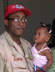 Staff Sgt. Rodney Blanton, 556th RHS, holds his daughter, Chelsey, during their last afternoon together before his deployment.  The 556th RED HORSE Squadron, a tenant unit to the 433rd Airlift Wing, Air Force Reserve Command, deploys first to Fort McCoy, Wis., for combat skills training before heading overseas to an undisclosed location. It will be deployed up to one year in support of Operations Iraqi and Enduring Freedom. The 556th is the only RED HORSE Squadron in the Air Force Reserve. (Photo by Staff Sgt. Carlos Trevino)