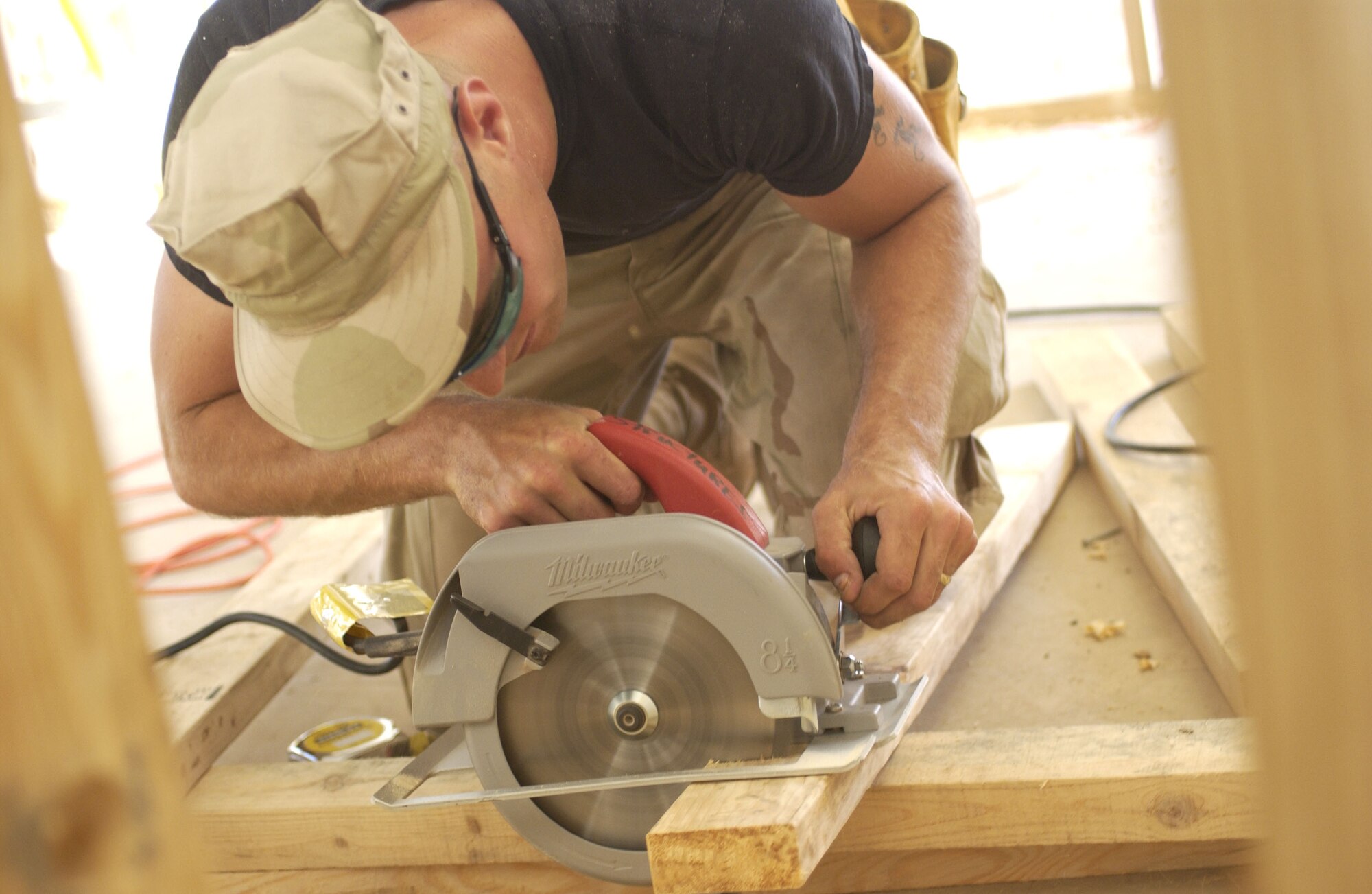 Senior Airman Josh Jankoski saws lumber to build a wall during an office building renovation at Balad Air Base, Iraq, on Thursday, April 20, 2006. Airman Jankoski is with the 557th Expeditionary Red Horse Squadron. (U.S. Air Force photo/Tech. Sgt. Denise Rayder)
