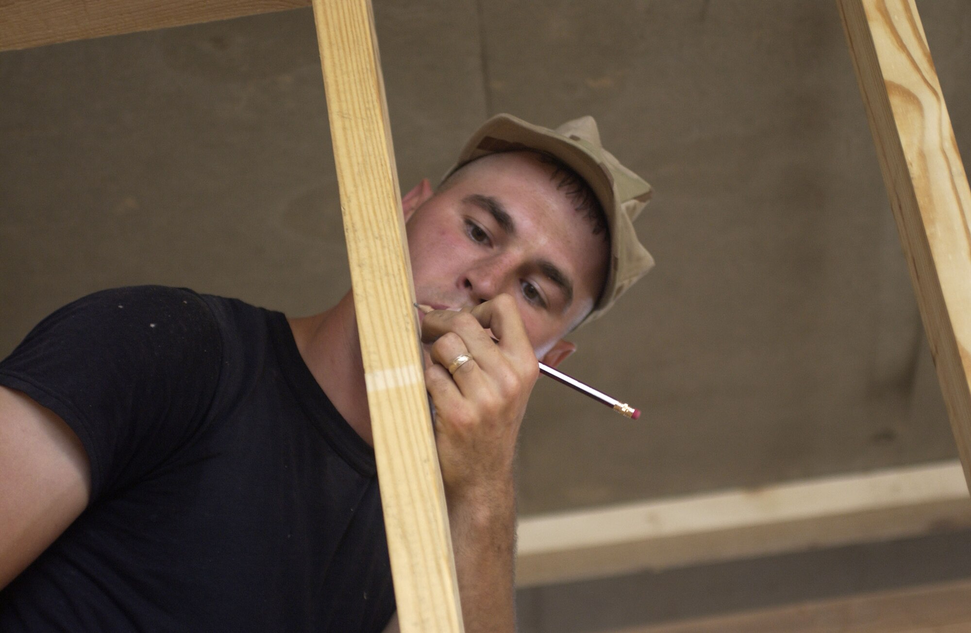 Senior Airman Josh Jankoski writes down measurements during renovation of an office building at Balad Air Base, Iraq, on Thursday, April 20, 2006. Airman Jankoski is with the 557th Expeditionary Red Horse Squadron. (U.S. Air Force photo/Tech. Sgt. Denise Rayder)
