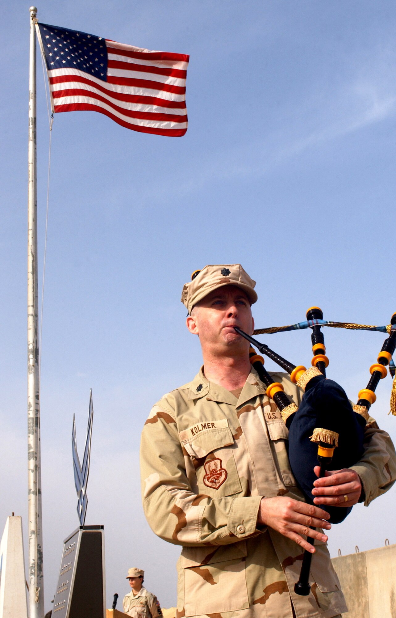 Lt. Col. Dave Kolmer plays the bagpipes during a recognition ceremony for the Fallen Airman Memorial on Wednesday, April 26, 2006, at Ali Base, Iraq. (U.S. Air Force photo/Staff Sgt. Bradley C. Church)