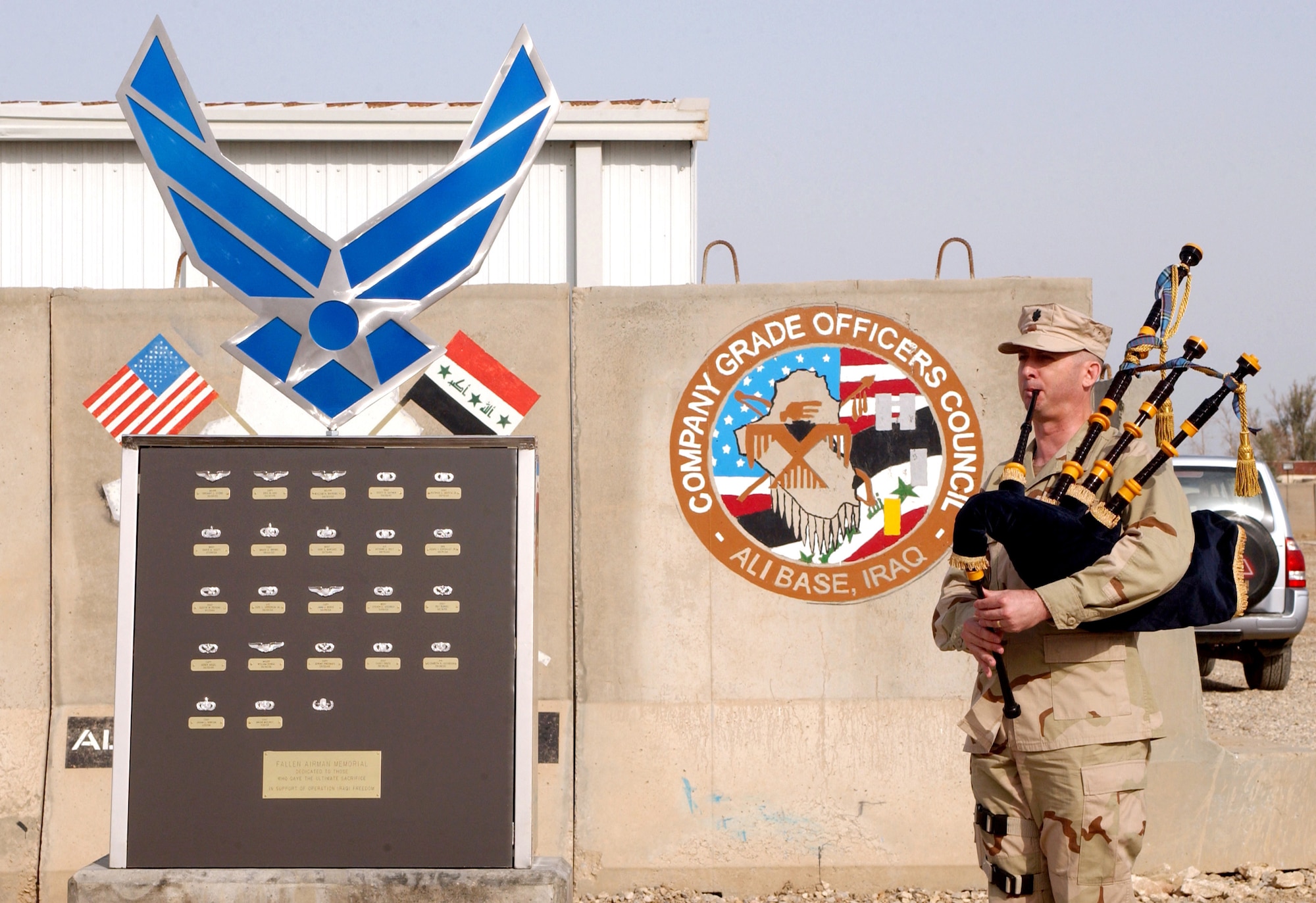 Lt. Col. Dave Kolmer plays the bagpipes during a recognition ceremony for the Fallen Airman Memorial on Wednesday, April 26, 2006, at Ali Base, Iraq. The memorial is dedicated to those who made the ultimate sacrifice in support of Operation Iraqi Freedom. (U.S. Air Force photo/Staff Sgt. Bradley C. Church)
