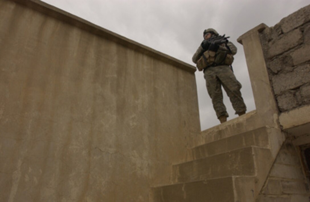 Army Sgt. Landon Gomez makes sure a rooftop is clear during a neighborhood patrol in Mosul, Iraq, on April 23, 2006. Gomez is deployed to Iraq with the 2nd Battalion, 1st Infantry Regiment, 172nd Infantry Brigade Combat Team. 