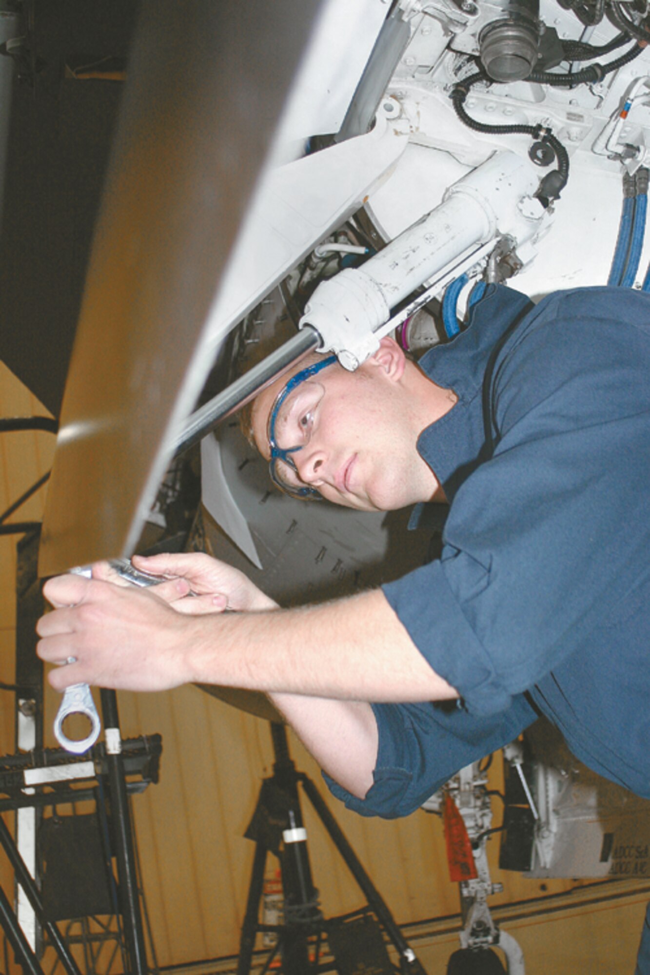 CANNON AIR FORCE BASE, N.M. - Senior Airman George McMillen, 27th EMS crew chief, tightens down the lower end attachment lug for the landing gear door actuator. The actuator shaft is required by technical order to be lubricated during the phase inspection. (U.S. Air Force photo by Staff Sgt. Craig Seals)