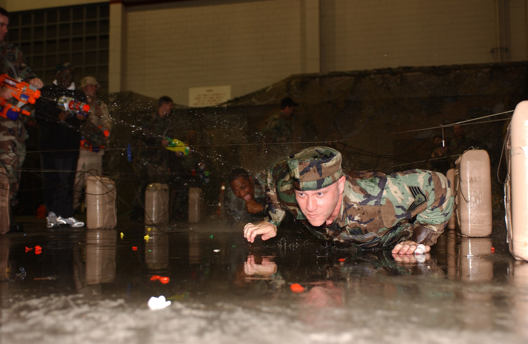 SSgt. Anthony Heskett from the 353rd Operations Support Squadron crawls through the first obstacle leading to the 353rd Special Operations Group Combat Dining Out April 22.  The dining out coincided with the 26th anniversary of Operation Eagle Claw.

       