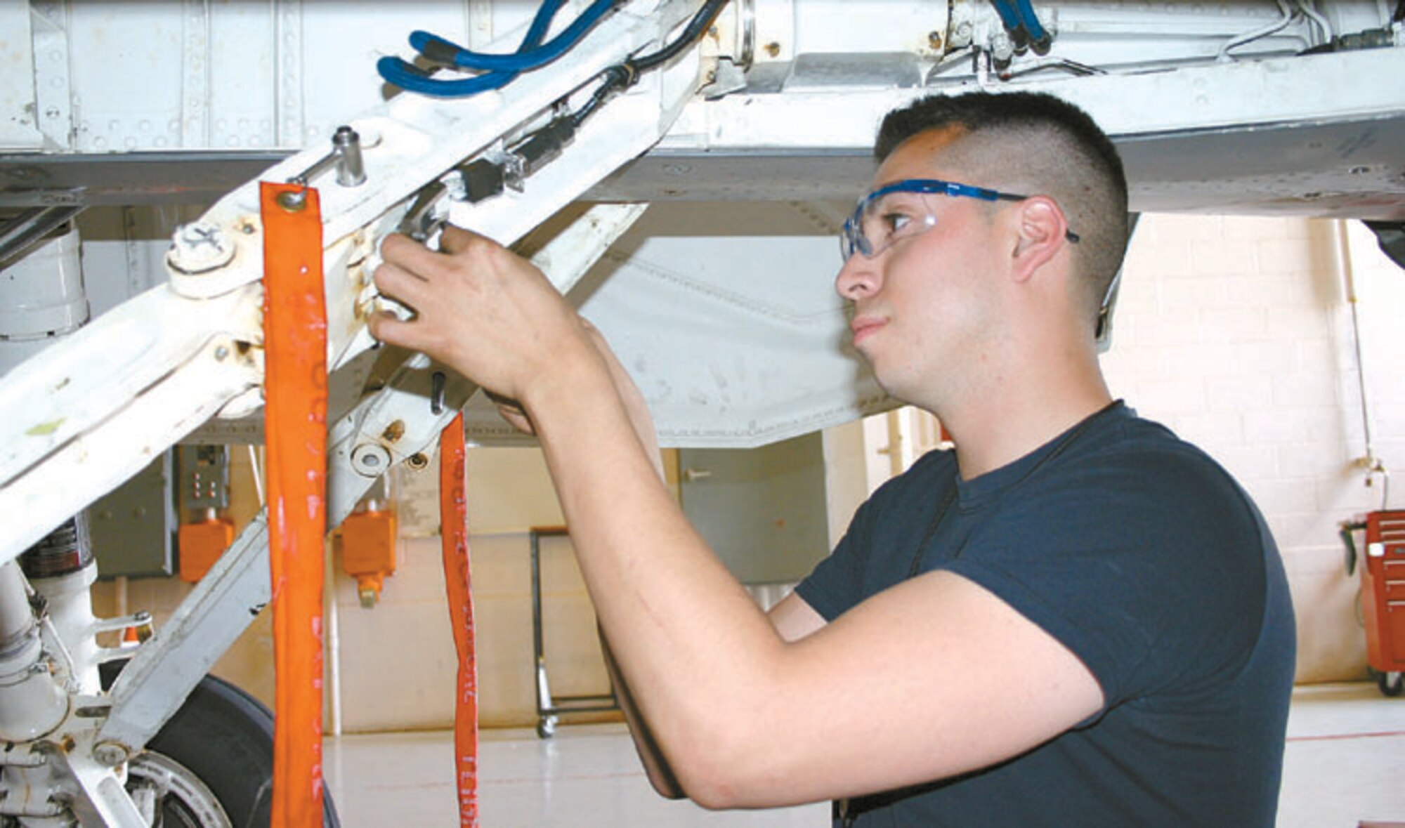 CANNON AIR FORCE BASE, N.M. - Senior Airman Caesar Rivera, 27th Equipment Maintenance Squadron, installs the down switch bracket on the drag brace of the aircraft’s right landing gear. Airman Rivera is a crew chief in the phase dock, Hangar 208. (U.S. Air Force photo by Staff Sgt. Craig Seals)