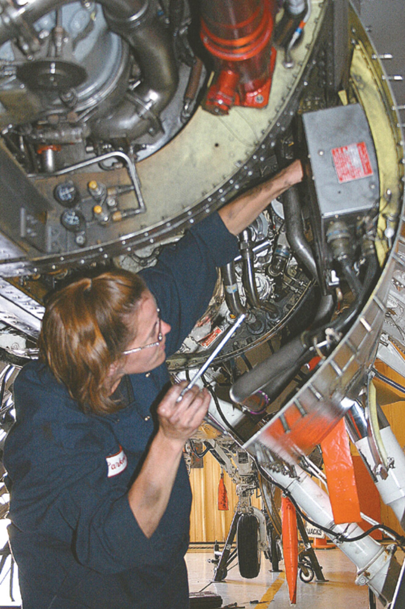 CANNON AIR FORCE BASE, N.M. - Tech. Sgt. Deanna Parker, 27th Equipment Maintenance Squadron, installs a frequency converter to the lower aircraft section of an F-16 during a phase inspection. During the inspection portion of the phase, a discrepancy was found with the converter and it needed to be changed. (U.S. Air Force photo by Staff Sgt. Craig Seals)