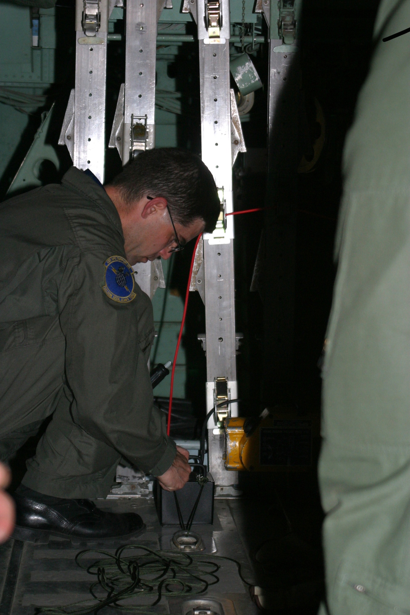 Tech. Sgt. Robert Russell sets up an emergency parachute jettison device in a cargo aircraft at Pope Air Force Base, N.C., on Tuesday, April 25, 2006. The EPJS was used for the first time April 25. The product has been in development and testing since 1997. Sergeant Russell is assigned to the 43rd Operational Support Squadron. (U.S. Air Force photo/Senior Airman Cassandra Locke)