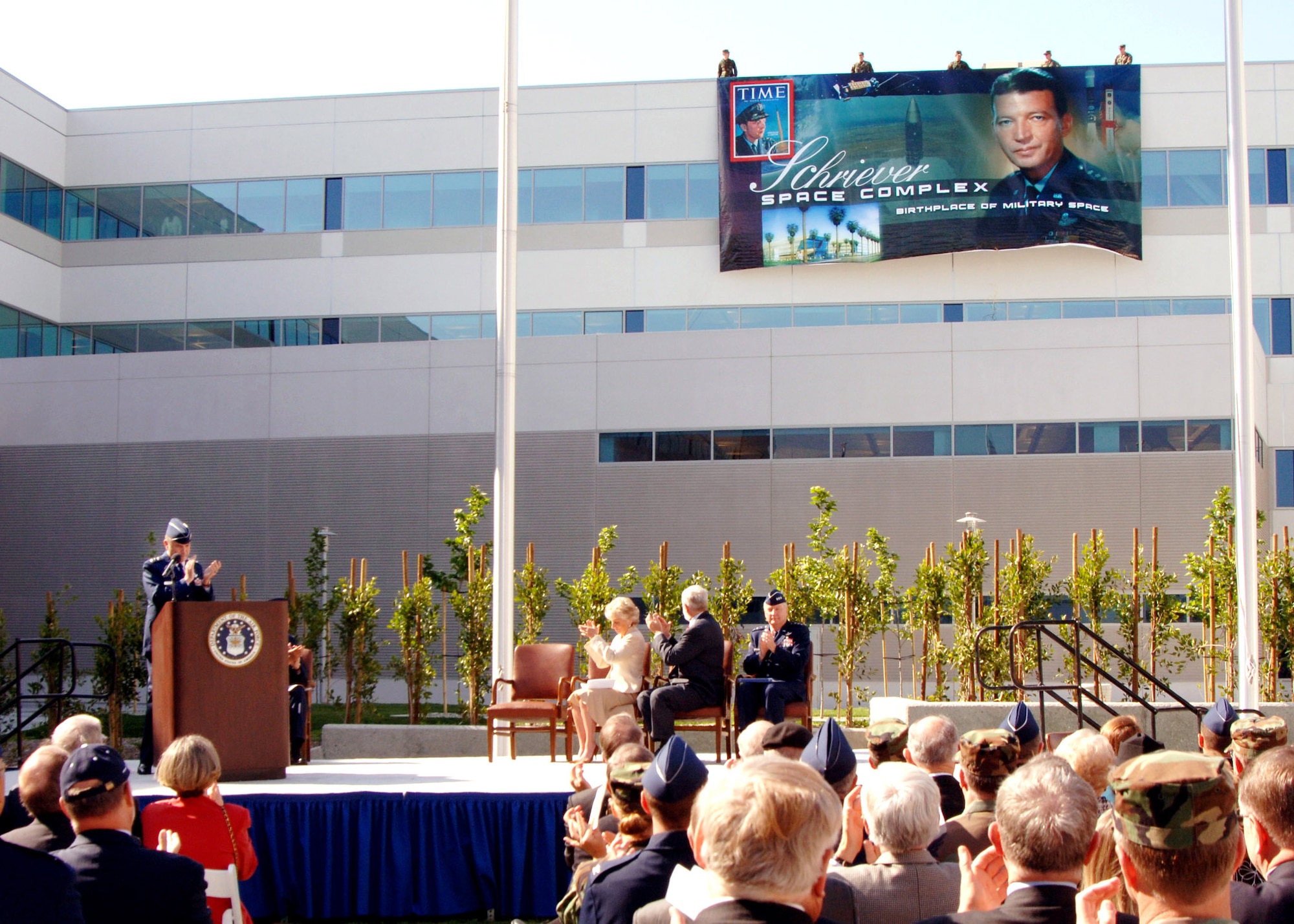 The audience applauds as a banner is unfurled during the dedication of the new Schriever Space Complex in El Segundo, Calif., on Monday, April 24, 2006. (U.S. Air Force photo/Teri Mathis) 
