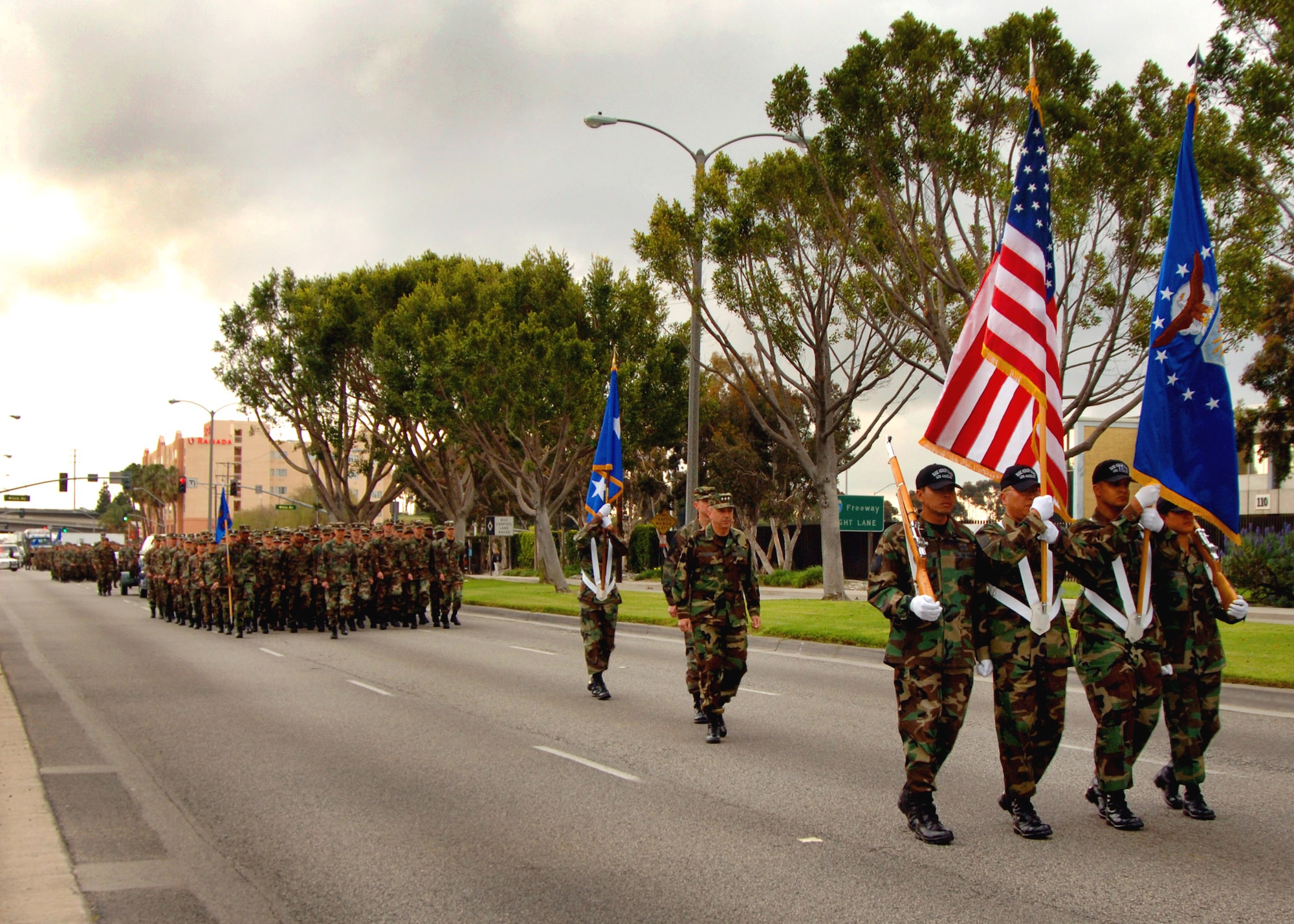 The Los Angeles Air Force Base Honor Guard leads Lt. Gen. Michael Hamel, Space and Missile Systems Center commander, and 300 base Airmen to the new Schriever Space Complex in El Segundo, Calif., on Monday, April 24, 2006. (U.S. Air Force photo/Teri Mathis) 
