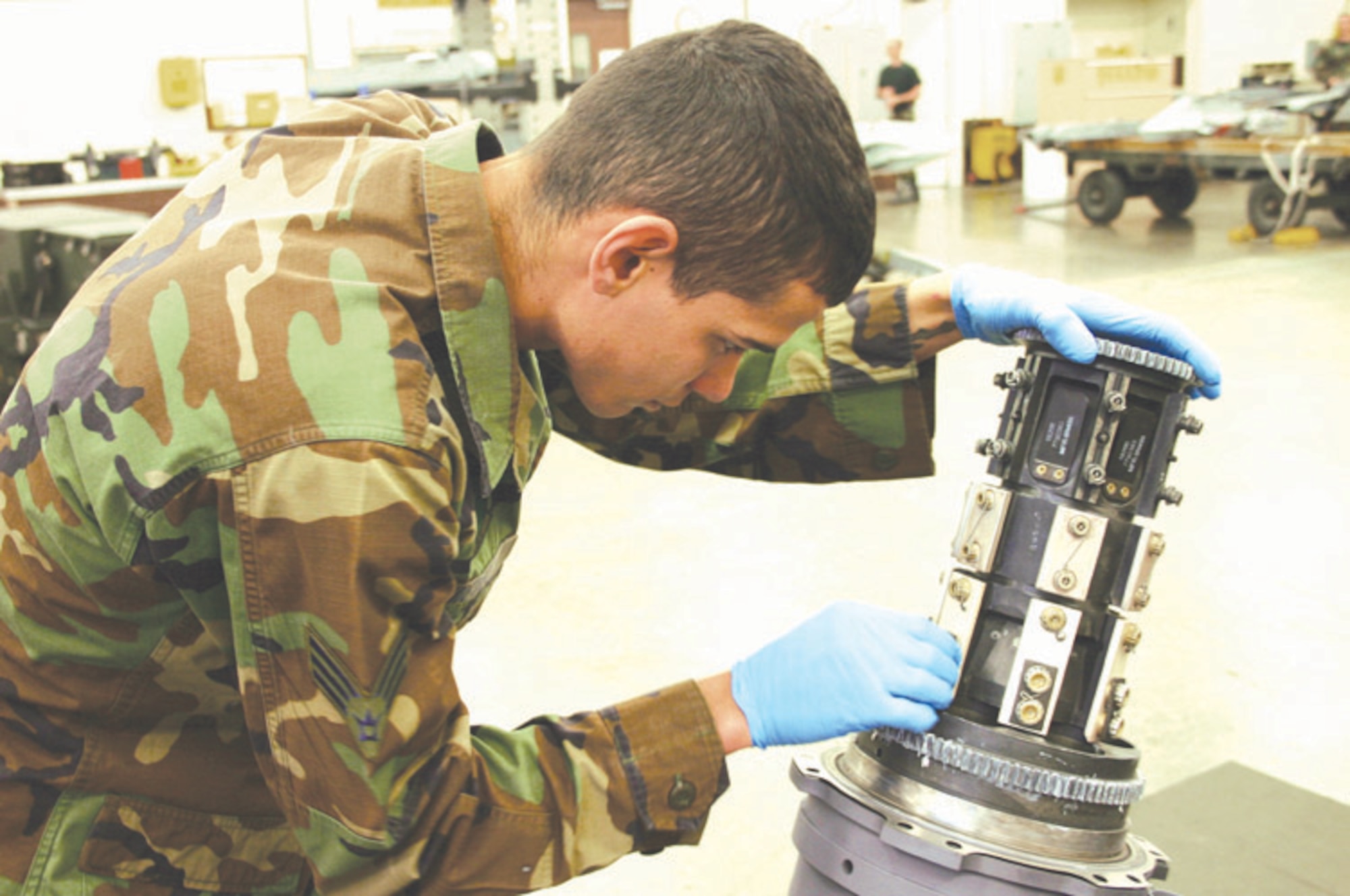 CANNON AIR FORCE BASE, N.M. - Senior Airman Wilfredo Nieves inspects the safety wires of the main gun system on a M61A1 20mm gun. Airman Nieves is part of the Armament Shop for the 27th Equipment Maintenance Squadron that has embarked on a new initiative to eliminate three days of aircraft downtime for each aircraft maintenance unit. (U.S. Air Force photo by Airman Thomas Trower)