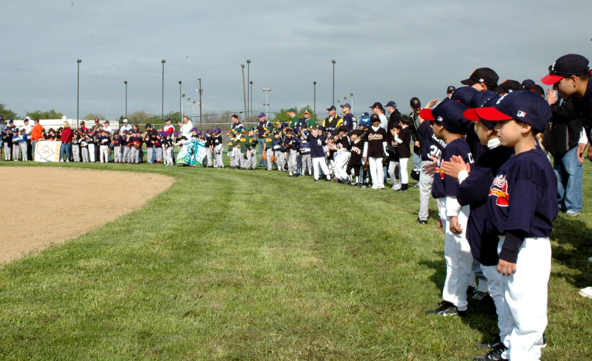 Saturday was a day filled with baseballs, gloves and bats as Travis' Little League Baseball celebrated this season's opening day. The Equestrian Center provided three horses for kids to ride on and Dinger, the Rivercats mascot, also made an appearance at the event. The opening ceremonies concluded with the field being rededicated in honor of Nick Bower, a Travis Little Leaguer who was killed by a drunken driver in 1996.  (Photo by Staff Sgt. Raymond Hoy, 60th AMW Public Affairs)