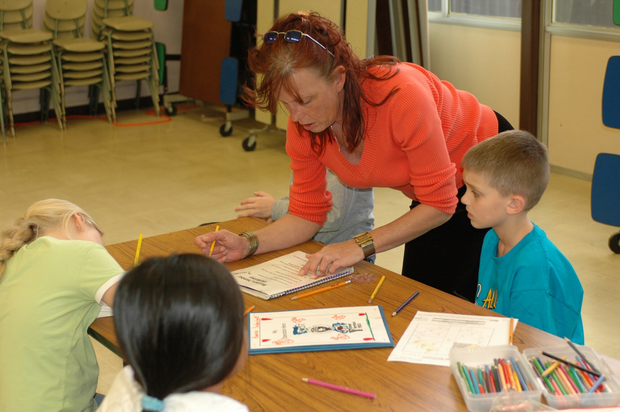 Ms. Linda Claus, Hero program director, provides homework help to children on base. More than 80 children take part in the program each semester. (Photo by Staff Sgt. Raymond Hoy, 60th AMW Public Affairs)