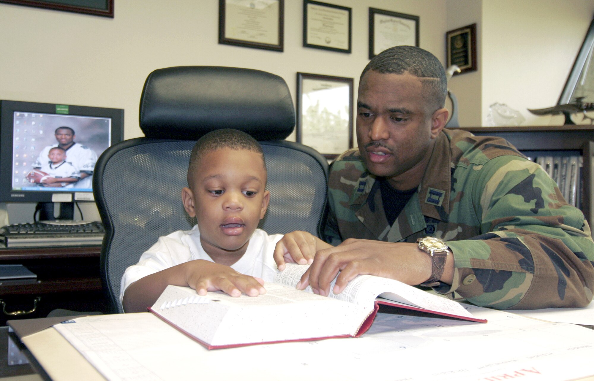 Khyre Silver visits his dad, Capt. Eric Silver, during the national Take Our Daughters and Sons to Work Day at Mountain Home Air Force Base, Idaho, on Thursday, April 27, 2006. Captain Silver is the 366th Fighter Wing executive officer. (U.S. Air Force photo/Senior Airman Brian Stives)
