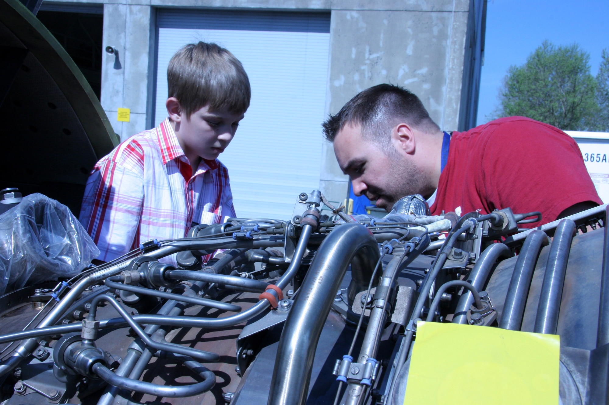 Staff Sgt. Carl Hojnacki, shows Cheis Hanzelic the moving parts of a KC-135 Stratotanker engine during Take Our Daughters and Sons to Work Day at the 939th Air Refueling Wing in Portland, Ore., on Thursday, April 27, 2006.  Sergeant Hojnacki is an engine mechanic with the 939th Maintenance Squadron. (U.S. Air Force photo/Ruby Zarzyczny)