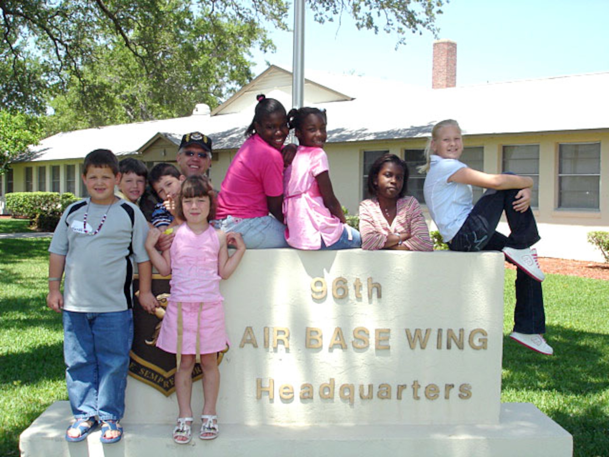 Col. Dean R. Clemons, 96th Air Base Wing vice commander, peaks out from behind a group of children visiting Eglin Air Force Base, Fla., during the wing's Take Our Daughters and Sons to Work Day event on Thursday, April 27, 2006. Pictured are Matheau Swank and Savannah Hatch (in front) and Isaac Clemons, Aiden O'Connor, Colonel Clemons, Brianna Heath, Mariah Parsons, Jasmin Scaife and Chelsea Grant. (U. S. Air Force photo)